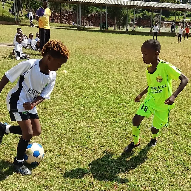 Santos Soka Academy — Lime green youth squad lined up with their coach
