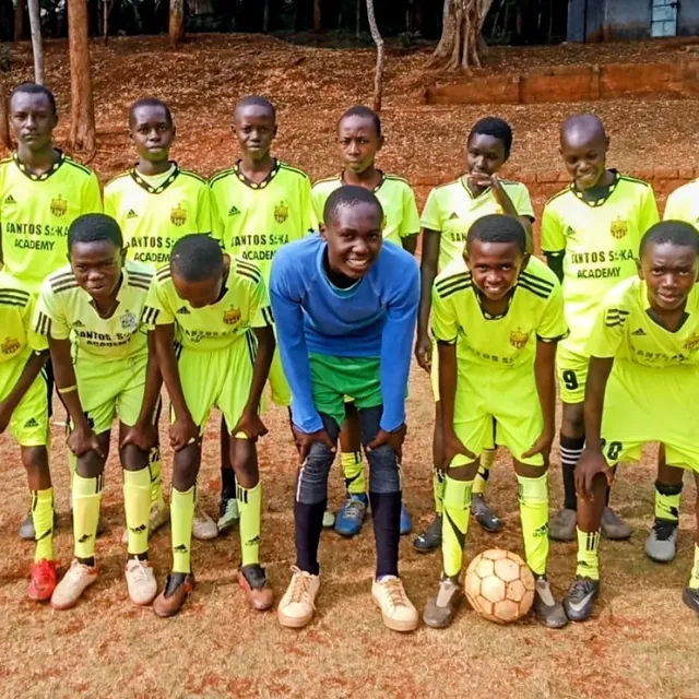 Santos Soka Academy teen squad in lime kits with their coach
