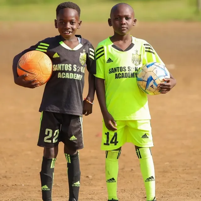 Santos Soka young players posing with footballs after a youth session